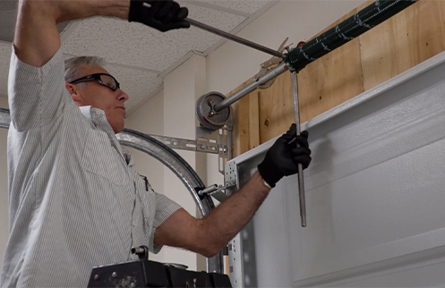 Technician Repairing Garage Door